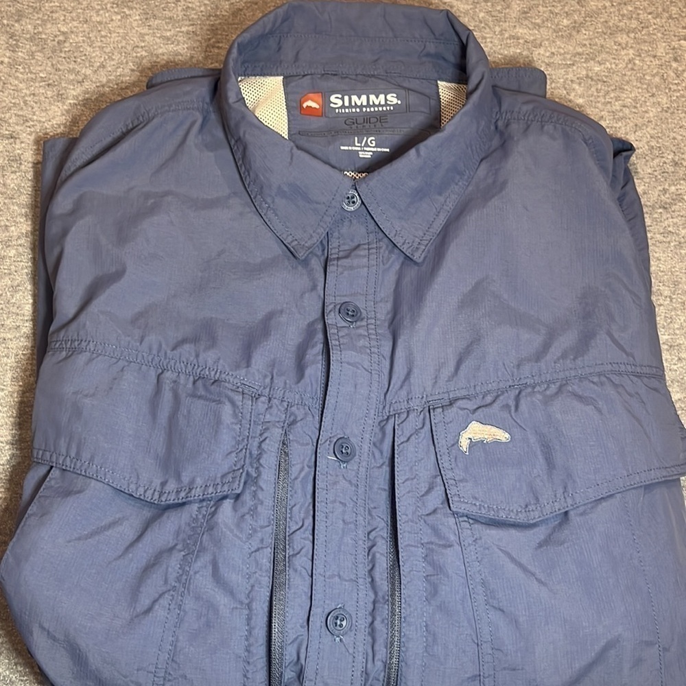 Simms fishing guide series long sleeve button blue shirt.
